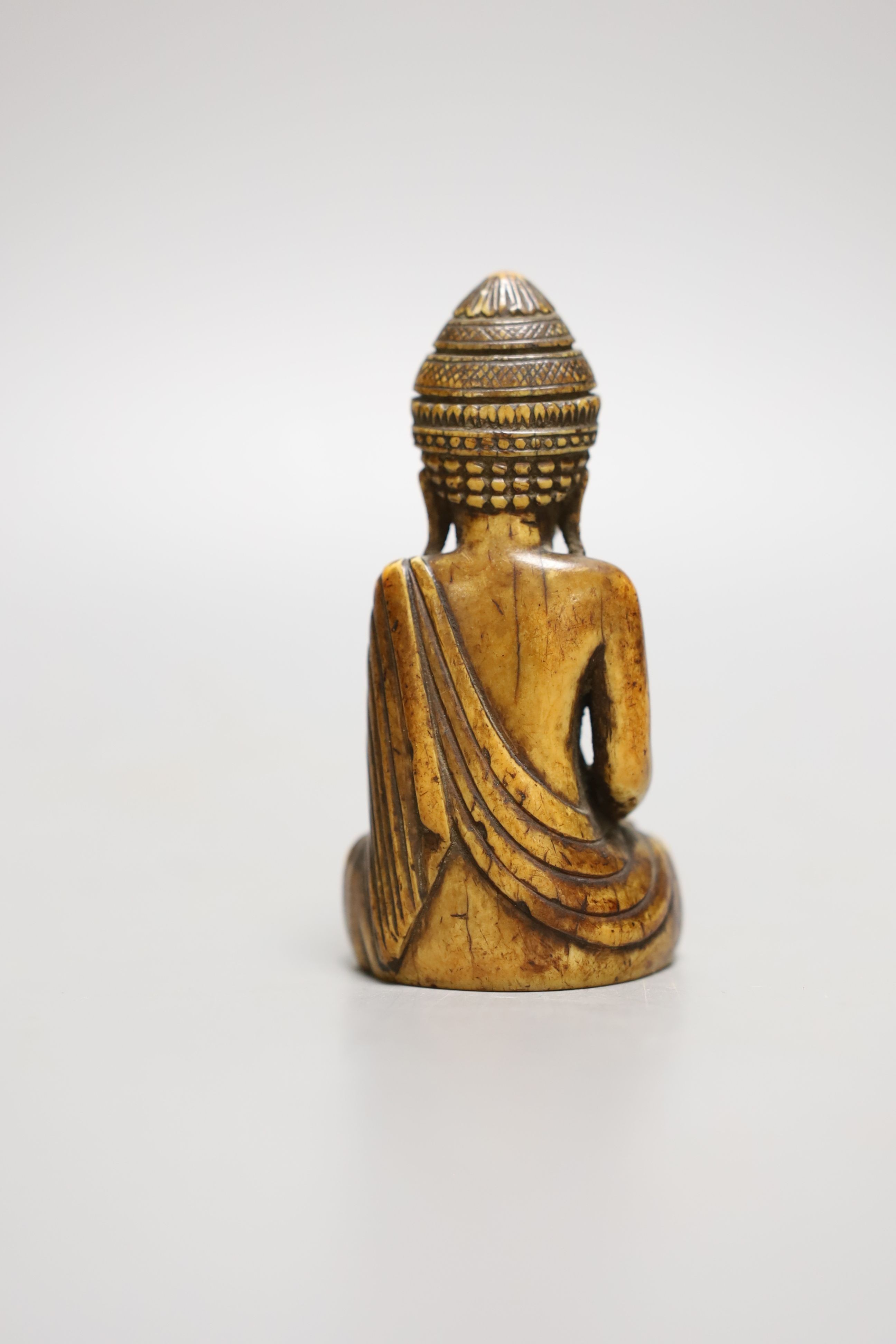 A Thai ivory buddha, probably 8th / 9th century, 9cms high.